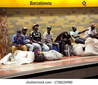 SPAIN, BARCELONA, JUNE, 28, 2015 - Street Vendors with large bales are waiting for a train in the subway in Barcelona, Spain. Street Vendors market the goods  much of which is counterfeit.
