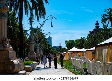 Spain, Barcelona - May 30 2022: Promenade Passeig De Lluís Companys In Front Of The Arc De Triomf. People Walk And Rest In The Park.