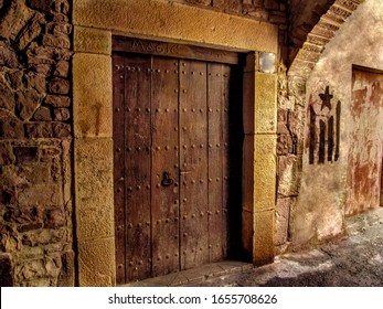 Spain, Cervera - October 10, 2018:  Ancient Wooden Door Of A Former Brothel With The Sign 'Magic' On The Medieval Street Of Cervera Town (Spain), Close-up. Vintage Background With Copy Space