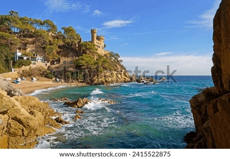 Spain. Coast of the Costa Brava. Catalonia. Lloret de Mar. Mediterranean Sea. Beautiful rocks. A sea wave hits the shore.