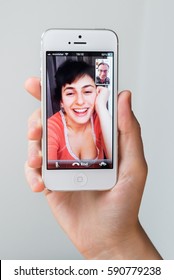 SPAIN - DECEMBER 10, 2013: Young woman talking via FaceTime on Apple iPhone