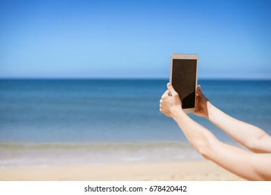 Spain, Europe - 24 June 2017: Busy Woman Using Apple Ipad 2 Smart Computer Device On Sandy Sea Beach Outdoors Background. Back Side View Of Modern Internet Working Person And Blank Display Copyspace