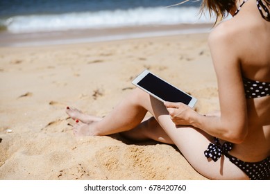 Spain, Europe - 24 June 2017: Busy Woman Using Apple Ipad 2 Smart Computer Device On Sandy Sea Beach Outdoors Background. Back Side View Of Modern Internet Working Person And Blank Display Copyspace