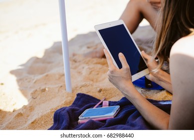 Spain, Europe - 24 June 2017: Busy Woman Using Apple Ipad 2 Smart Computer Device On Sandy Sea Beach Outdoors Background. Back Side View Of Modern Internet Working Person And Blank Display Copyspace