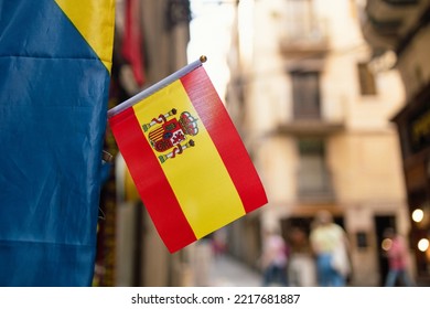  Spain Flag Waving In Front Of A Building In A Beautiful Summer Day On The Main Street Of The City Background