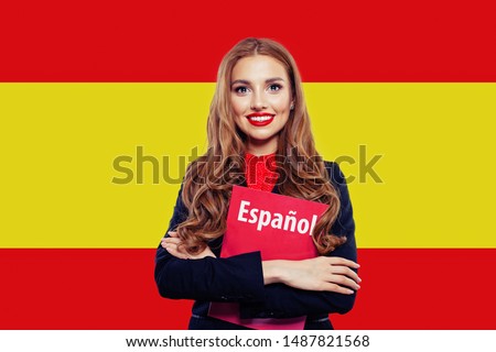 Spain. Happy student girl with red book against the spanish flag background. Travel and learn spanish language
. Book with inscription Spanish on spanish language