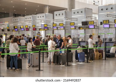 Málaga, Spain, June 16, 2022; Travelers With Suitcases Queuing For Check-in At Malaga Airport Counters.