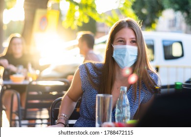 Spain Madrid. Caucasian Woman Wearing Sanitary Mask. Reopen Pubs And Club After Quarantine Coronavirus Covid-19. Woman Drinking Beer. People Smiling In Masks. Summer 2020 New Normal