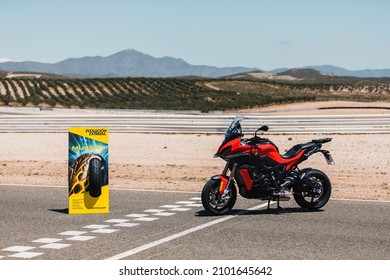 Almería, Spain - May 4th 2021: A red BMW motorbike and Dunlop Mutant Tyres advertisement totem on the circuit finish line, during Dunlop Xperience showroom and test in Almería, Spain.