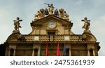 Spain, Pamplona, Plaza Consistorial, Pamplona City Council (Ayuntamiento de Pamplona - Iruñeko Udala), portico of the building with a clock and a balcony