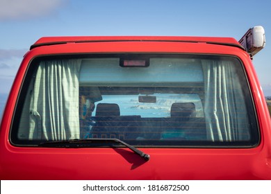 Spain; Sep 2020: Views Of The Ocean And The Coastline Through The Rear Window Of An Old Van, Red Campervan Parked In Front Of The Sea, Low Cost Touristic Route By The Atlantic Ocean, Asturias, Spain