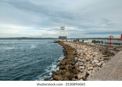 A Coruña, Spain September 28th 2024: A scenic coastal view in La Coruña, Spain, featuring a modern bridge and a rocky shoreline along the bay.  - Powered by Shutterstock