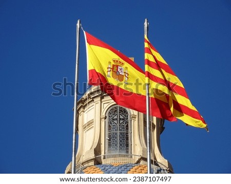 [Spain] Spanish flag and Catalan flag with blue sky (Barcelona)