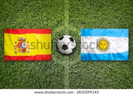Spain vs. Argentinia flags on green soccer field or football field