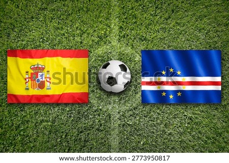 Spain vs. Cape Verde flags on a green soccer field
