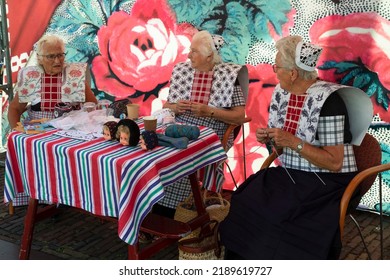 Spakenburg, Netherlands, August 3, 2022; Three Spakenburg Ladies In Traditional Costume Knit Together On The Spakenburg Days.