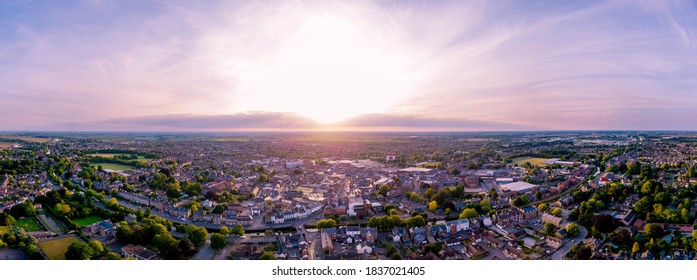 SPALDING, LINCOLNSHIRE / UK - May 21 2020: Aerial Panorama of the Georgian market town of Spalding at sunset including South Holland Centre, River Welland, Chatterton Water Tower & Ayscoughee Hall