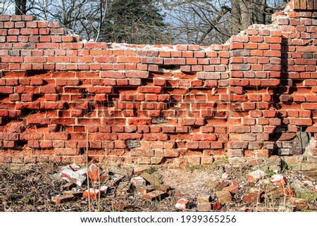 Spalling bricks, crumbling old brick wall
