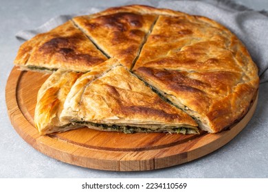 Spanakopita, greek phyllo pastry pie with spinach and feta cheese filling. Delicious handmade pies. Turkish name; el acmasi borek - Powered by Shutterstock