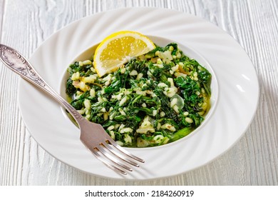 Spanakorizo, Greek Spinach And Rice Pilaf With Lemon, Dill, Spring Onion In White Bowl With Fork On White Wooden Table, Horizontal View From Above, Close-up