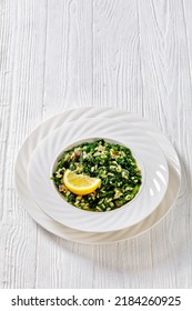 Spanakorizo, Greek Spinach And Rice Pilaf With Lemon, Dill, Spring Onion In White Bowl On White Wooden Table, Vertical View From Above