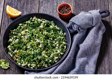 Spanakorizo, Greek Spinach And Rice Pilaf With Lemon, Dill, Spring Onion In Frying Pan On Dark Wooden Table, Horizontal View From Above