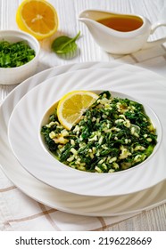 Spanakorizo, Greek Spinach And Rice Pilaf With Lemon, Dill, Spring Onion In White Bowl On White Wooden Table, Vertical View From Above, Close-up