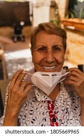 Spanish Blonde Grandmother Smiling With Mask Removed At Family Reunion