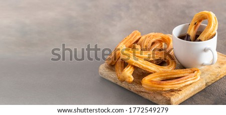 Spanish churros, fried-dough pastry served  usually with chocolate. Traditional breakfast everywhere in Spain. Large background for banner.Copy space