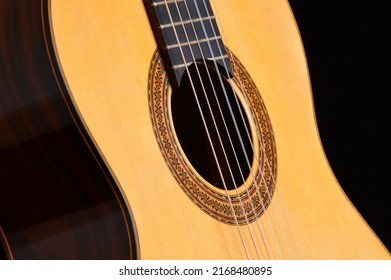 Spanish classic guitar gyrating, detail of mouth, strings, frets and wood