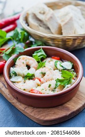 Spanish cuisine delicacy - gambas tapas -  fresh cooked king prawns with garlic, chili and parsley in the terracotta dish .