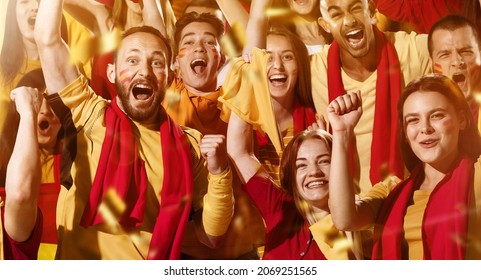 Spanish emotive football, soccer fans cheering their team with a red scarfs at stadium. Excited fans rejoice goal, supporting favourite players. Concept of sport, emotions, team event, competition.