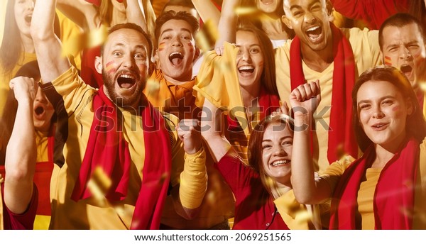 Spanish emotive football, soccer fans\
cheering their team with a red scarfs at stadium. Excited fans\
rejoice goal, supporting favourite players. Concept of sport,\
emotions, team event,\
competition.