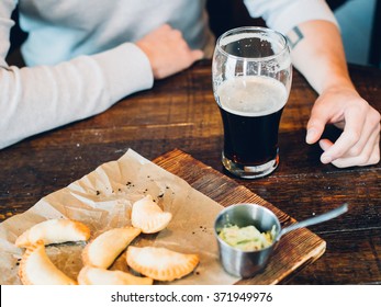 Spanish Empanadas With Dark And Light Beer In A Pub, Male Hands