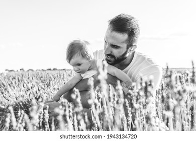 Spanish Father With His Daughter Having Fun In A Field Of Flowers. Spanish Family Into A Field Of Lavanda Flowers. Latin American Father Having Fun With Baby Outdoors. Family Concept.