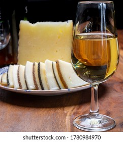 Spanish Fino Dry Sherry Wine From Andalusia And Pieces Of Different Sheep Hard Manchego Cheeses Made In La Mancha, Spain. Wine And Cheese Pairing