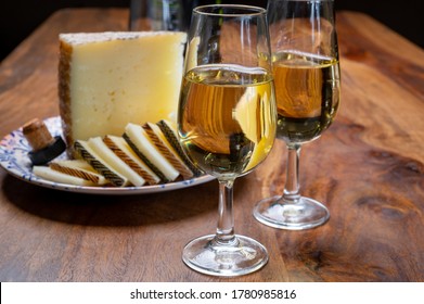 Spanish Fino Dry Sherry Wine From Andalusia And Pieces Of Different Sheep Hard Manchego Cheeses Made In La Mancha, Spain. Wine And Cheese Pairing