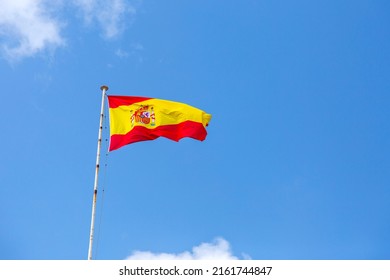 Spanish Flag Waving In The Clear Blue Sky. 