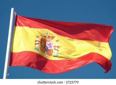 Spanish Flag Waving To The Wind Against The Sky