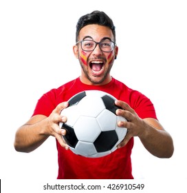 Spanish football fan holding a ball and shouting - Powered by Shutterstock