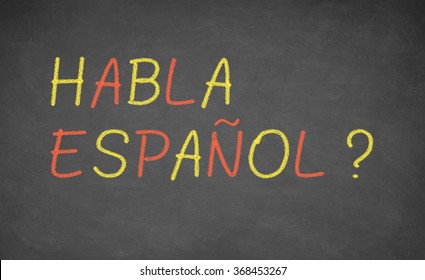 Spanish Language Learning Concept Image. Teacher Or Student Wrote HABLA ESPANOL On Blackboard During Spanish Language Course Class.