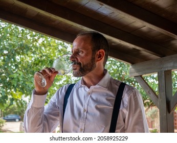 A Spanish Man Drinking White Wine