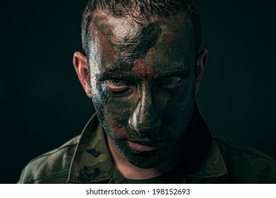 Spanish Military With Camouflage Paint On Face On Black Background