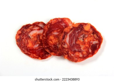 Spanish pork chorizo salami sausage slice on white. Chorizo iberian extra sausage slice with spices - Shutterstock ID 2223438893