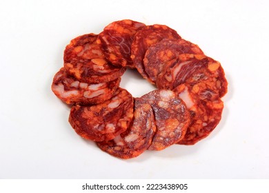 Spanish pork chorizo salami sausage slice on white. Chorizo iberian extra sausage slice with spices - Shutterstock ID 2223438905