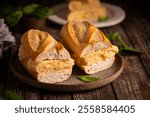 Spanish potato omelette sandwich. Typical Spanish food, Bocadillo de tortilla espanola very popular snack in Spain on white rustic background