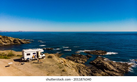 Spanish Rocky Coastline With Camper Car Camping On Cliff Sea Shore. Mediterranean Region Of Villaricos, Almeria, Eastern Andalusia, Spain.