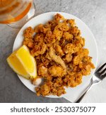 Spanish seafood dish chipirones a la andaluza, battered squid served with slice of lemon