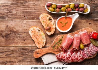 Spanish Tapas And Red Wine On Wooden Table, Top View