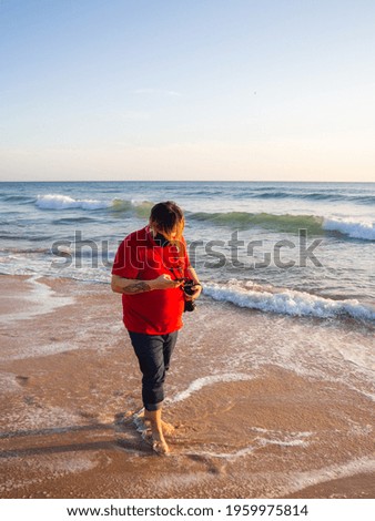 Similar – Man standing barefoot on a wooden walkway